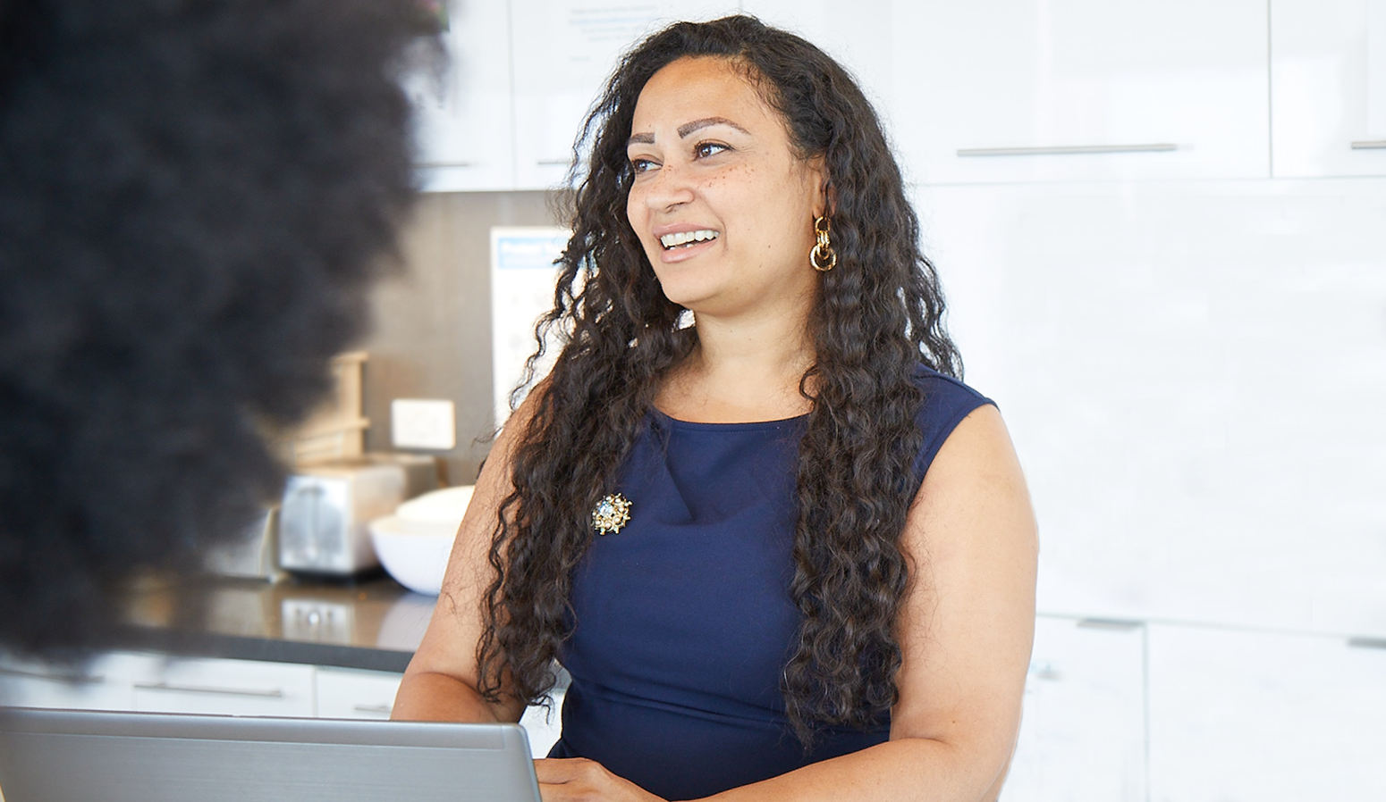 Female Lazard Colleague Smiling and Talking in Kitchen